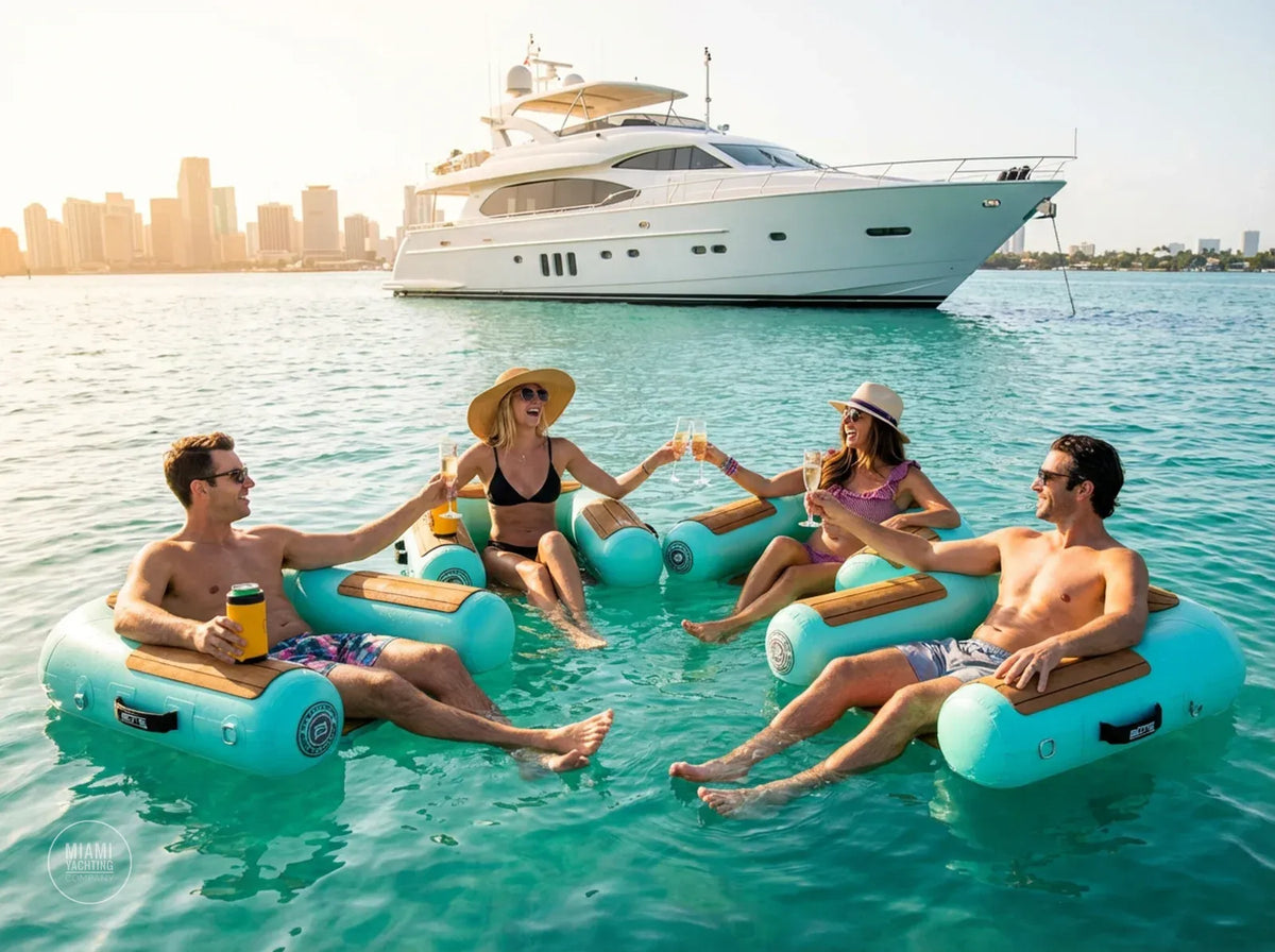 Guests relaxing in turquoise floating chill chairs next to a yacht