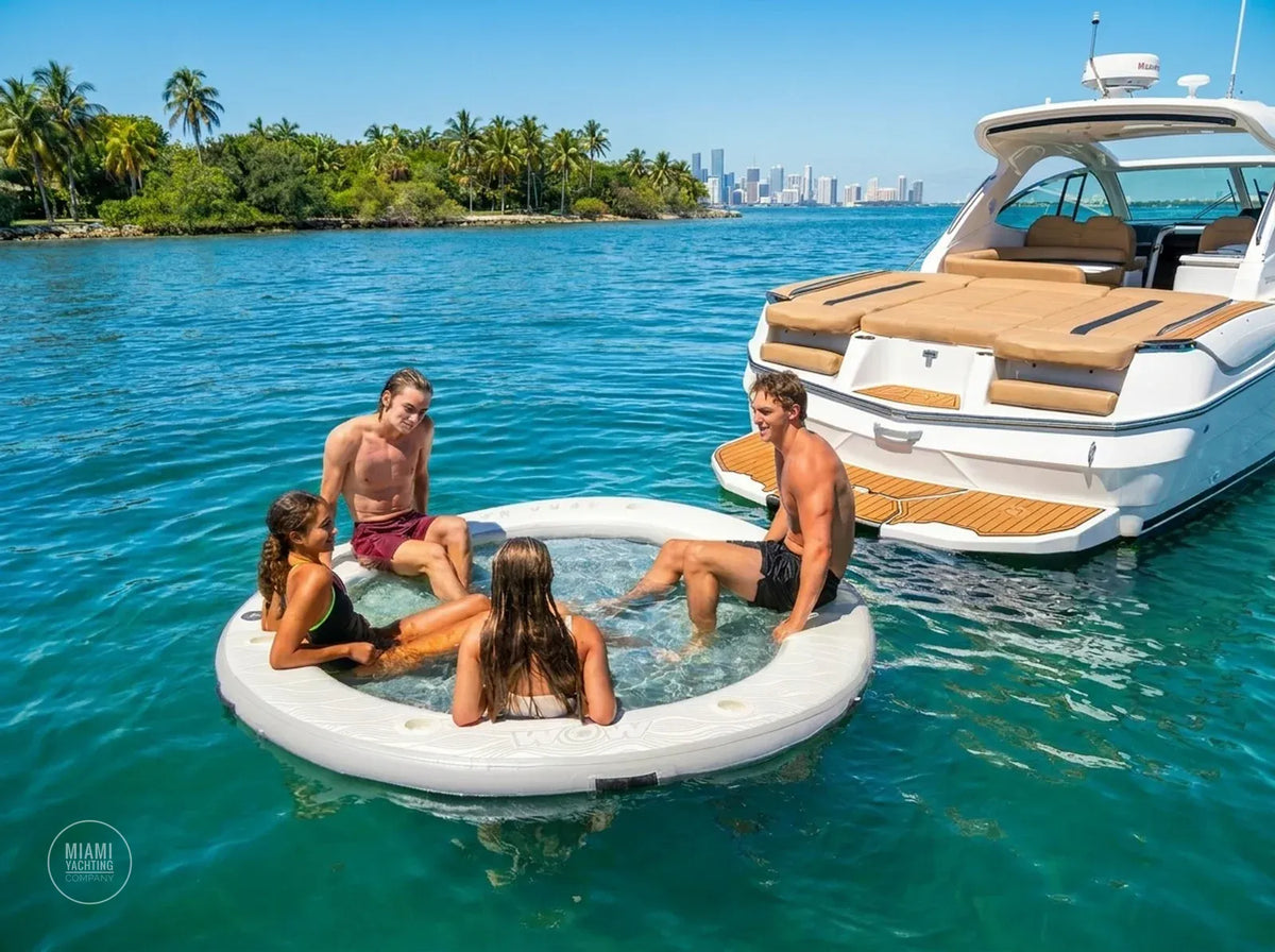 Guests relaxing in a floating water hammock beside a boat